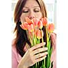 Mature woman holding bouquet of flowers