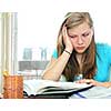 Teenage girl studying with textbooks looking unhappy