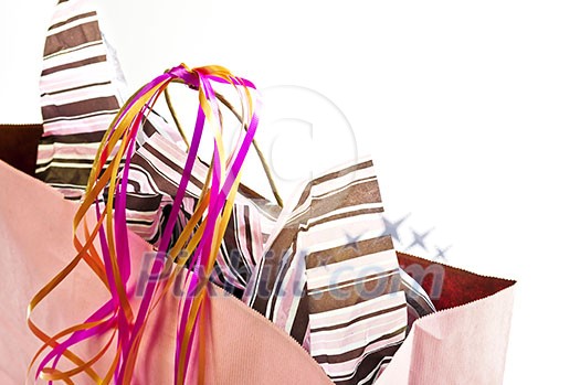 Pink shopping bag with ribbons isolated on white background Pink shopping bag with ribbons isolated on white background