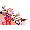 Pink shopping bag with ribbons isolated on white background