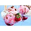 Strawberry ice cream sundae with fresh strawberries and walnuts