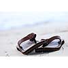 Flipflops on a sandy ocean beach - summer vacation concept