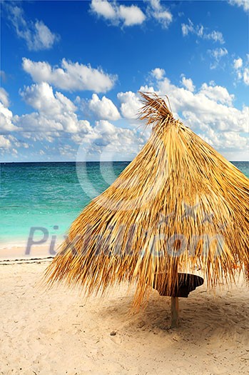 Tropical beach of a Caribbean island with palm branches shelter Tropical beach of a Caribbean island with palm branches shelter