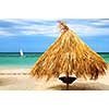Tropical beach of a Caribbean island with palm branches shelter