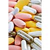 Mix of vitamins and herbal supplements close up