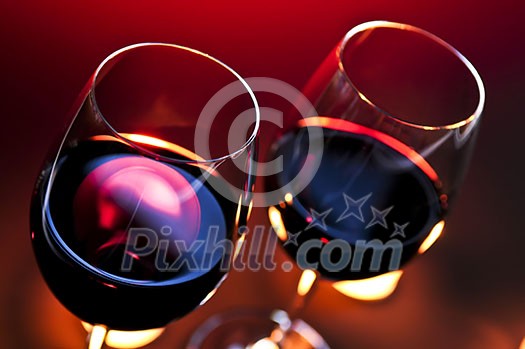 Two wineglasses with red wine at candlelight Two wineglasses with red wine at candlelight