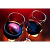 Two wineglasses with red wine at candlelight