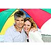 Portrait of happy mature couple under umbrella