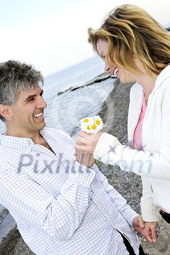 Mature couple enjoying a romantic moment with flowers Mature couple enjoying a romantic moment with flowers