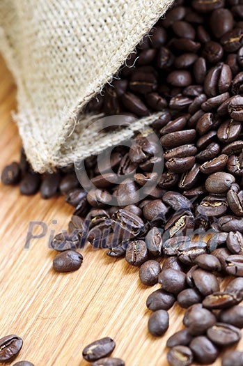 Roasted coffee beans in a rustic canvas bag Roasted coffee beans in a rustic canvas bag