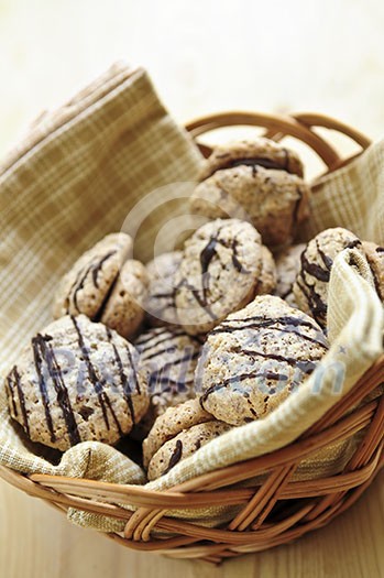 Fresh hazelnut chocolate sandwich cookies in a basket Fresh hazelnut chocolate sandwich cookies in a basket