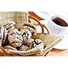 Fresh sandwich cookies in a basket and espresso coffee