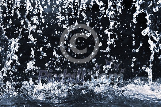 Falling water drops on dark background close up Falling water drops on dark background close up