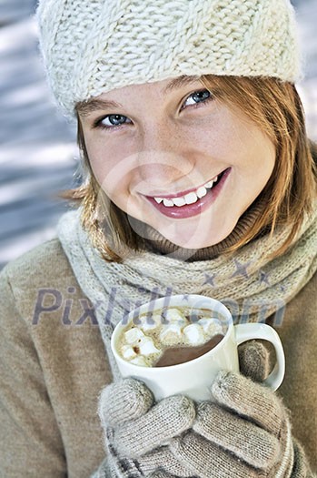 Teenage girl in winter hat with cup of hot chocolate Teenage girl in winter hat with cup of hot chocolate