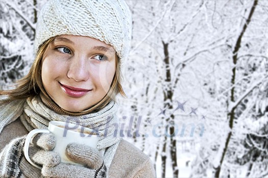 Teenage girl in winter hat with cup of hot chocolate Teenage girl in winter hat with cup of hot chocolate