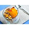 Serving of yogurt with fresh peaches and granola