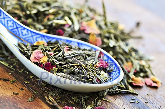 Green tea loose dry leaves in a spoon Green tea loose dry leaves in a spoon