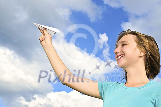 Young teenage girl holding a paper airplane Young teenage girl holding a paper airplane