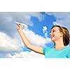 Young teenage girl holding a paper airplane