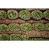 Stack of rolled grass sod or turf for lawns and landscaping