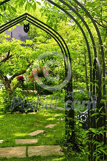 Lush green garden with wrought iron arbor