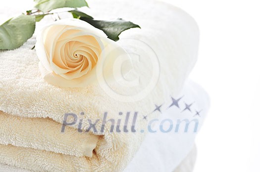 Stack of soft luxury towels with fresh flower Stack of soft luxury towels with fresh flower
