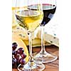 Wineglasses with red and white wine and assorted cheeses