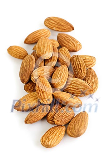 Raw almonds in a pile isolated on white background