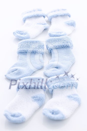 Arrangement of three pairs of blue infant boy socks for baby shower Arrangement of three pairs of blue infant boy socks for baby shower