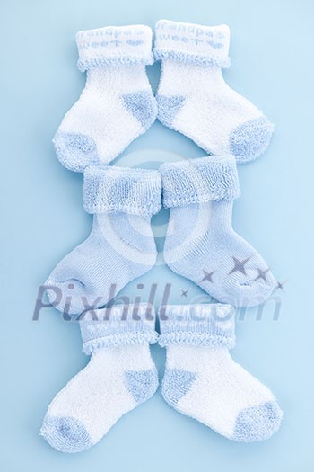 Arrangement of three pairs of blue infant boy socks for baby shower Arrangement of three pairs of blue infant boy socks for baby shower