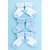 Arrangement of three pairs of blue infant boy socks for baby shower