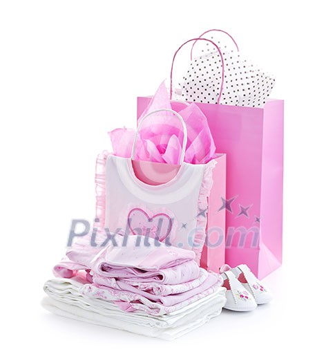Pink gift bags and infant clothes for girl baby shower isolated on white Pink gift bags and infant clothes for girl baby shower isolated on white