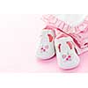 Infant girl clothing and shoes for baby shower on pink background