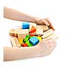 Hands gathering pile of wooden block toys isolated on white