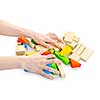 Hands with pile of wooden block toys isolated on white
