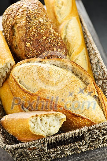 Various kinds of fresh baked bread in basket Various kinds of fresh baked bread in basket