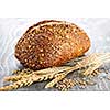 Loaf of fresh baked multigrain bread with grain ears