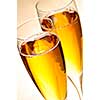 Two full champagne flutes with sparkling wine
