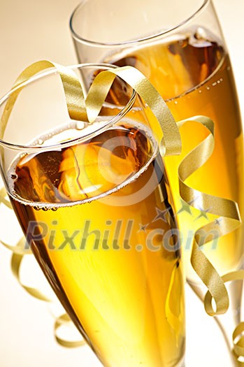 Two full champagne flutes with sparkling wine and ribbon Two full champagne flutes with sparkling wine and ribbon