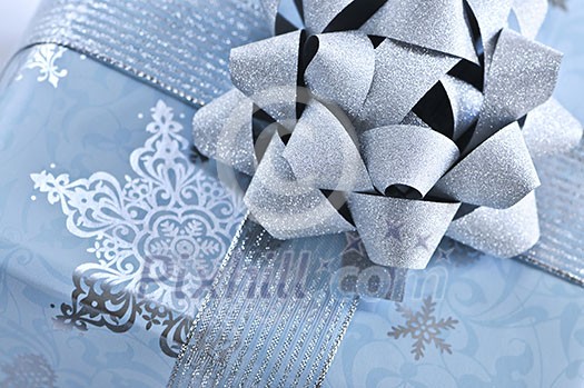 Christmas gift box wrapped in blue paper with silver ribbon close up Christmas gift box wrapped in blue paper with silver ribbon close up