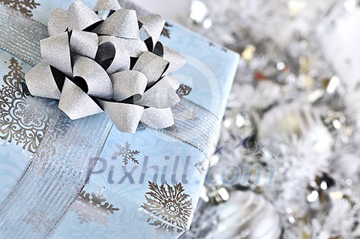 Wrapped gift box with silver Christmas ornaments Wrapped gift box with silver Christmas ornaments