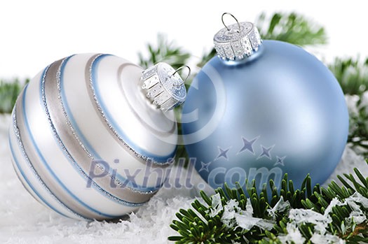 Two Christmas decorations in snow with pine branches Two Christmas decorations in snow with pine branches