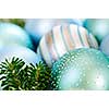 Many Christmas decorations laying in pine branches