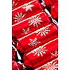 Closeup of many red Christmas crackers in a row