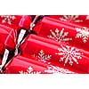 Closeup of many red Christmas crackers in a row