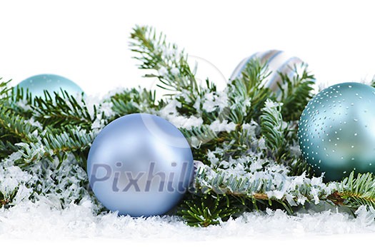 Many Christmas decorations laying in pine branches and snow Many Christmas decorations laying in pine branches and snow