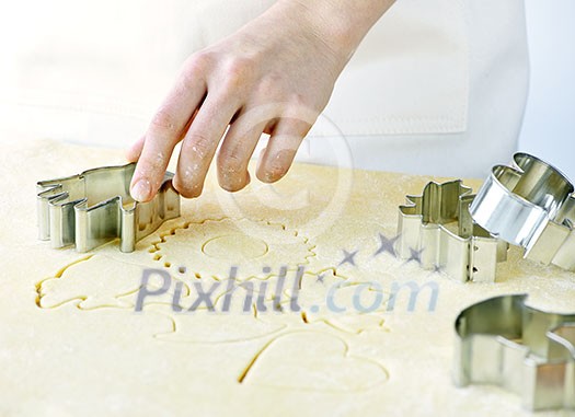 Cutting cookie shapes in rolled dough with cutter Cutting cookie shapes in rolled dough with cutter