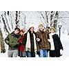 Group of diverse young friends walking outdoors in winter park