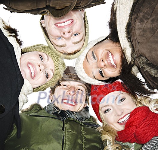 Faces of happy diverse young friends from below Faces of happy diverse young friends from below