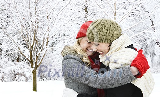 Portrait of two young girl friends hugging outdoors in winter Portrait of two young girl friends hugging outdoors in winter